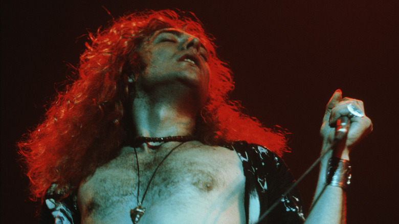Robert Plant on stage with shirt open