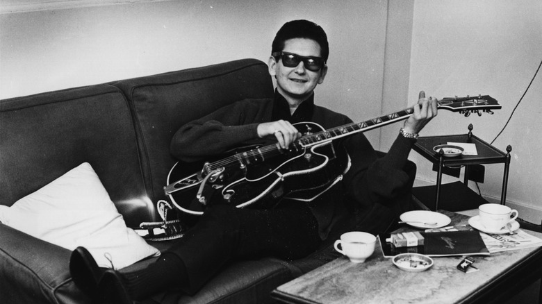 Roy Orbison on couch with guitar