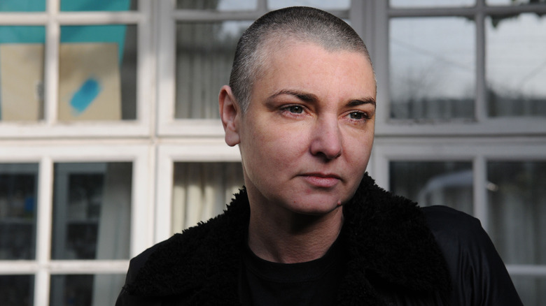 Sinead O'Connor frowning with shaved head