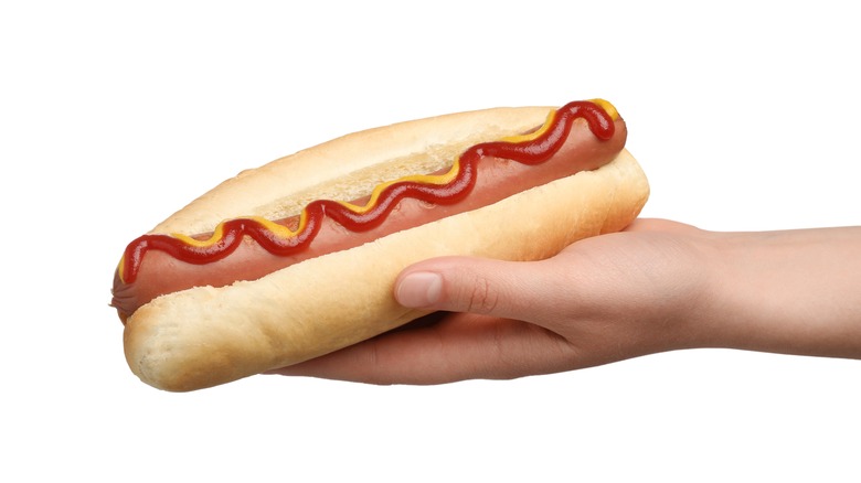 Woman holding hot dog