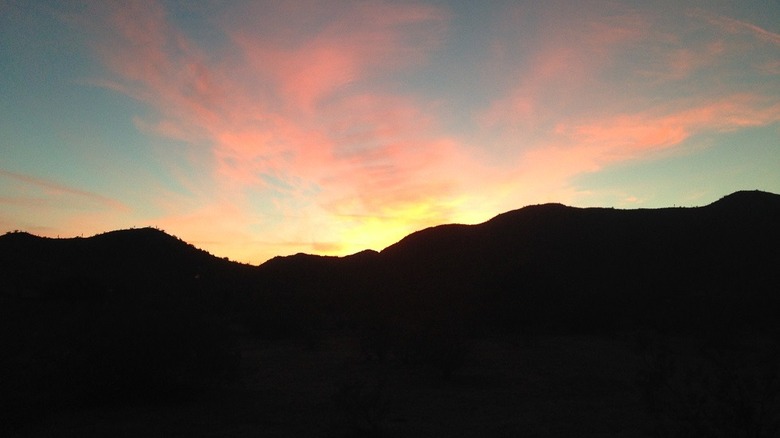 Photo of the sun setting over Casa Grande Mountain.