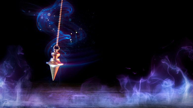 Pendulum swinging through purple energy