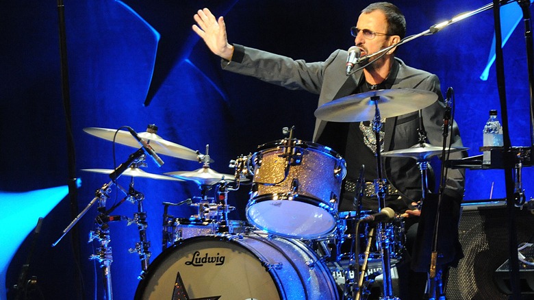 Ringo Starr waving from behind the drums