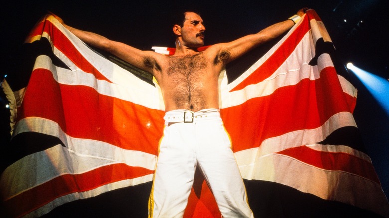 Freddie Mercury holding open British flag