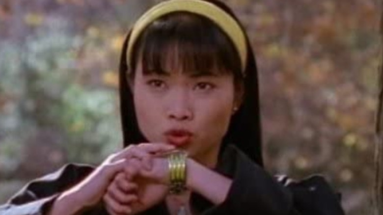 Thuy Trang speaking into watch