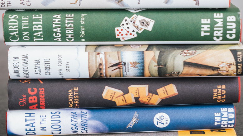 Stack of Agatha Christie novels, including "Cards on the Table"