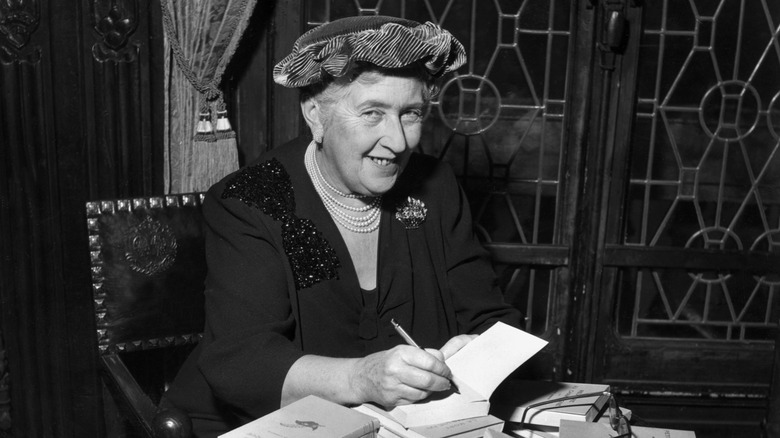 Photo of Agatha Christie autographing books