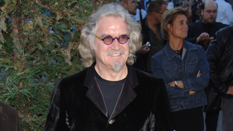Billy Connolly in purple glasses