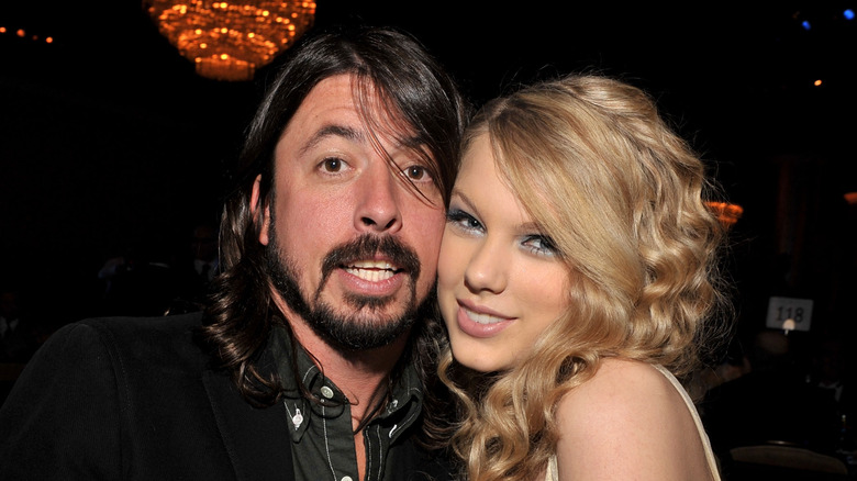 Dave Grohl and Taylor Swift touching cheeks