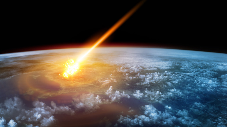 Flaming meteor striking earth from space