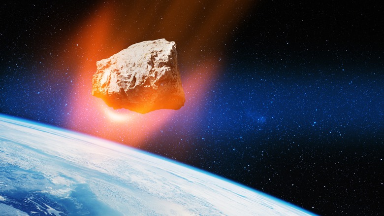 Asteroid glowing above earth