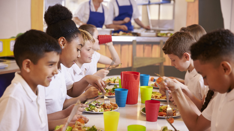 Kids eating in a cafeteria 