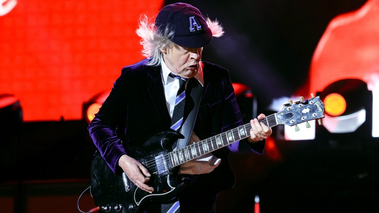 Angus Young playing guitar onstage