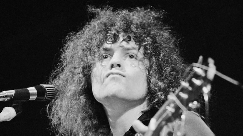 Marc Bolan playing guitar onstage