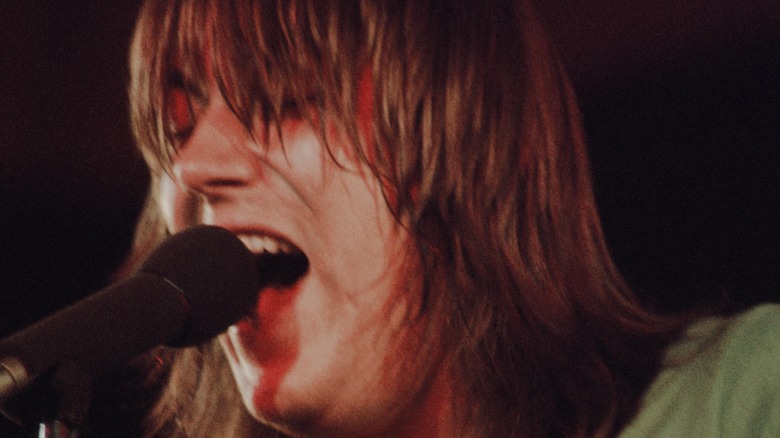 Terry Kath singing into microphone