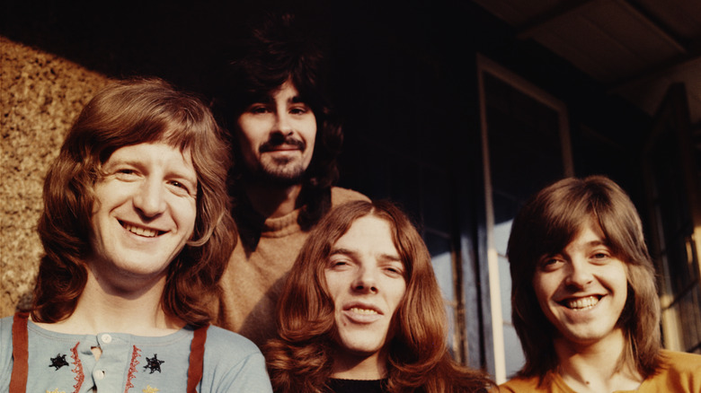 The members of Badfinger posing and smiling