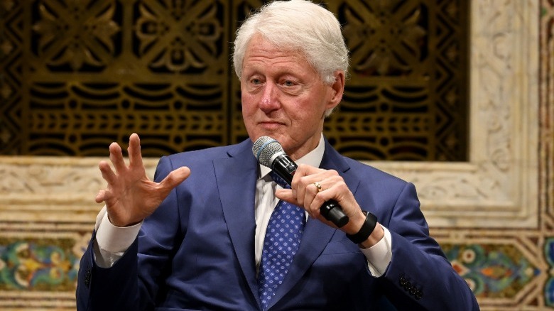 Bill Clinton speaking into microphone