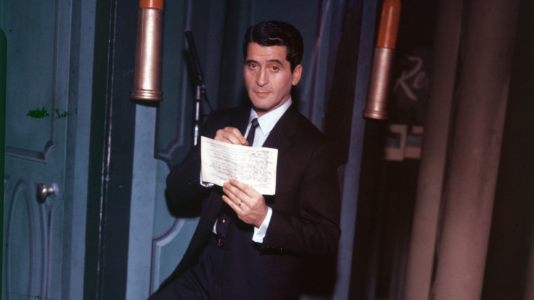 Host Hal March holding questions for "The $64,000 Question" in 1956