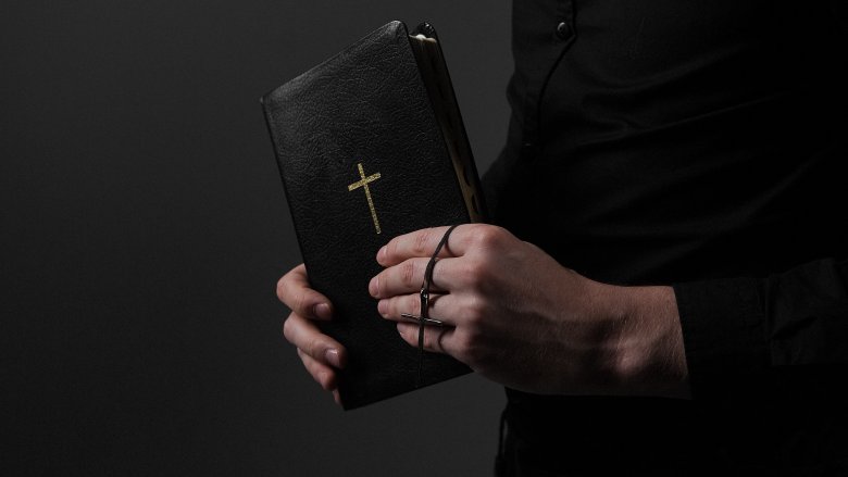 Bible in priest's hands