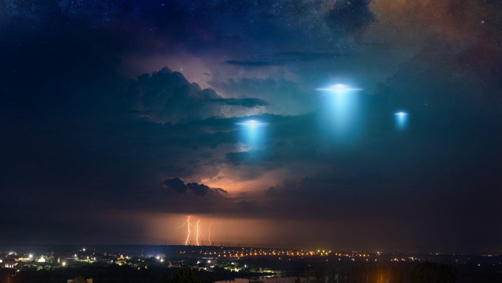 An artist's rendition of UFOs over a town