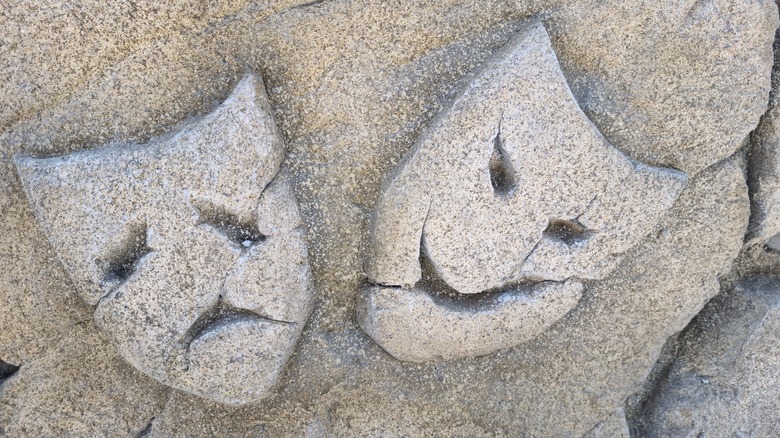 theatre masks carved in stone