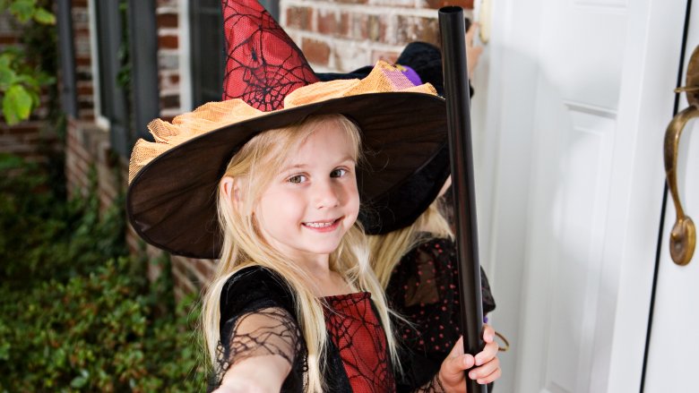 girl trick-or-treating witch
