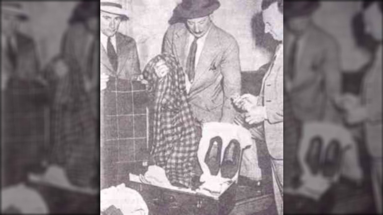 The suitcase belonging to The Somerton Man, found at Adelaide railway station. From left to right are detectives Dave Bartlett, Lionel Leane, and Len Brown.