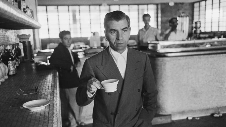 Lucky Luciano holding coffee cup