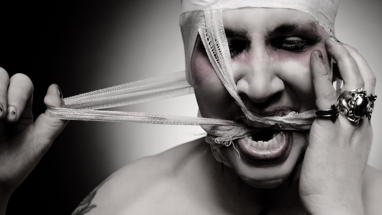 Marilyn Manson biting bandages