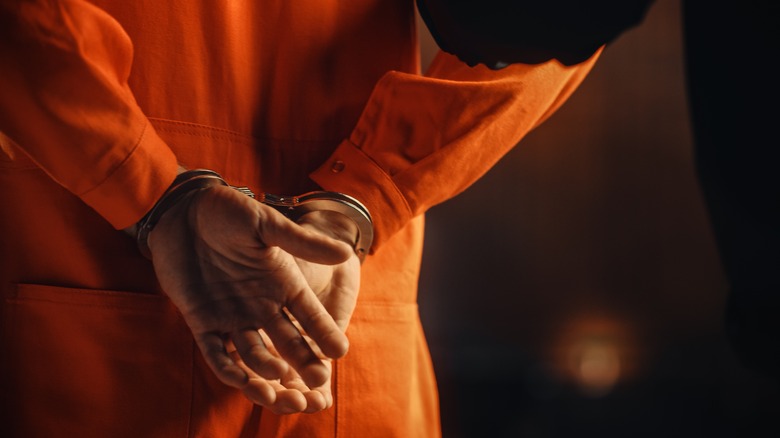 Man in orange prison jumpsuit
