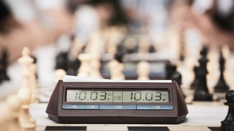 Chess clock beside a board