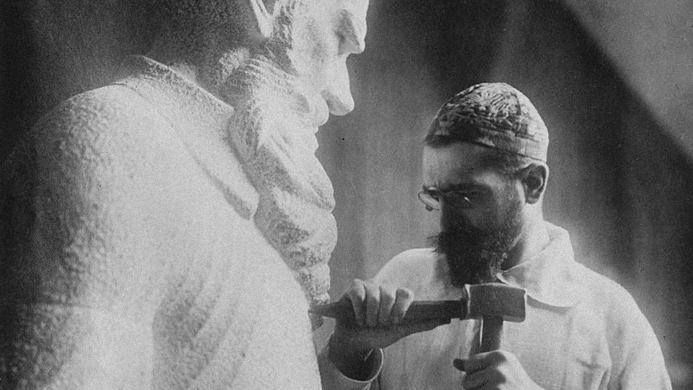 Russian sculptor Sergey Merkurov (1881-1952) working on his statue of Leo Tolstoy