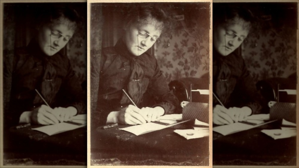 Edwardian woman writing at a desk