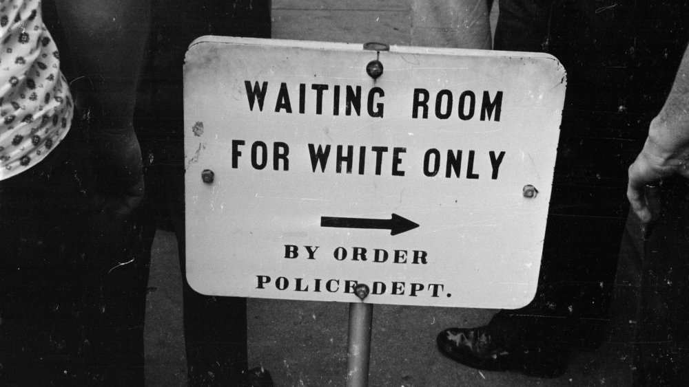 A police sign for a 'white only' waiting room