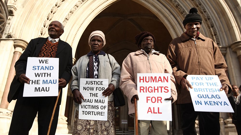 Kenyans (L-R) Wambugu Wa Nyingi, Jane Muthoni, Paulo Nzili and Ndiku Mutua stand outside the High Court on April 7, 2011 in London, England. 