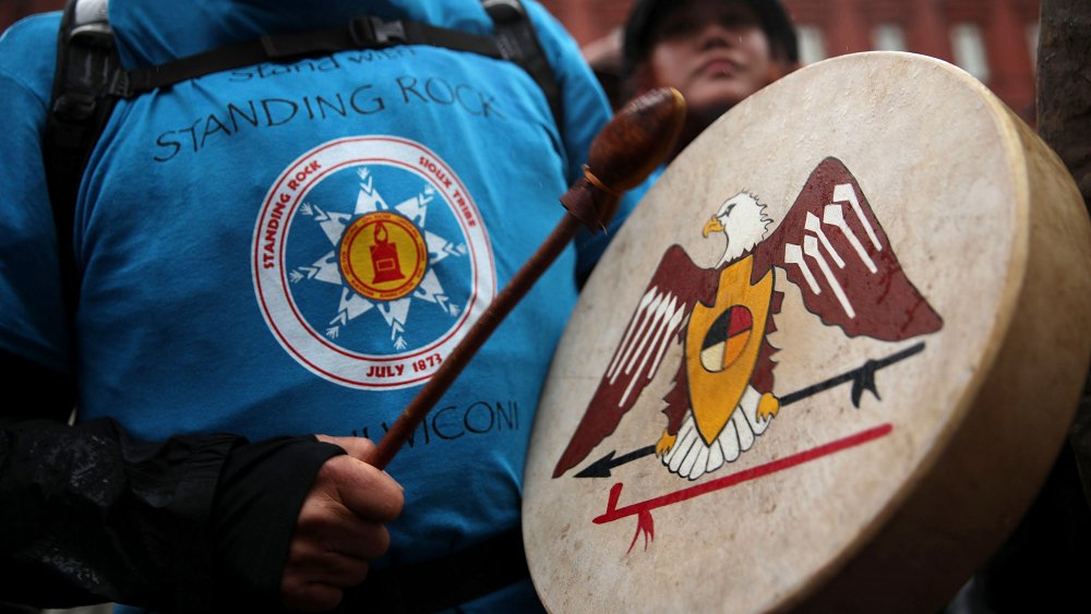 Activist at Standing Rock with drum