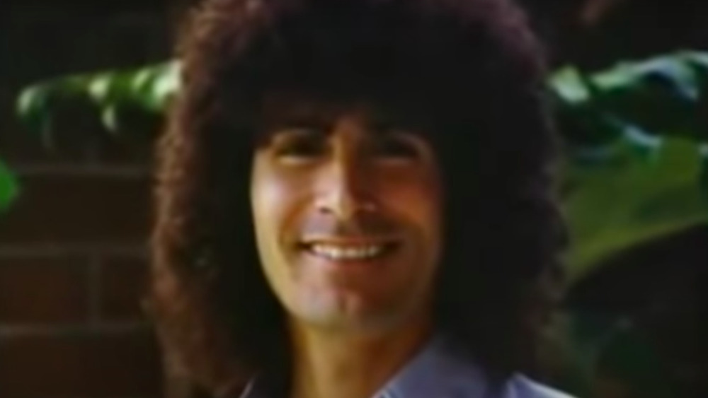 Rodney Alcala with bushy hair and smiling 