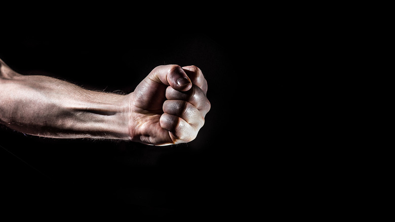 clenched fist on black background