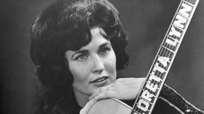 Loretta Lynn holding guitar 1962
