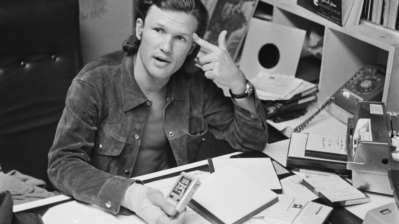 Kris Kristofferson at cluttered desk 1970