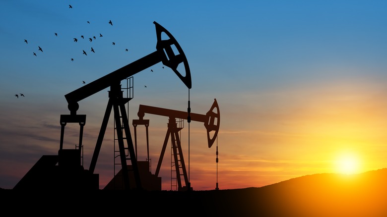 oil wells against sunset