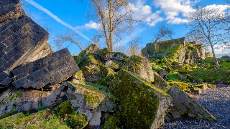rubble covered in green grass under blue sky