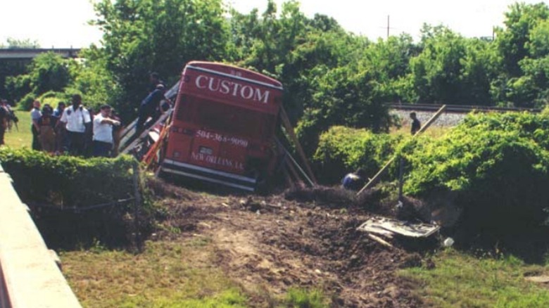 red bus labeled Custom in ditch mothers day crash 1999