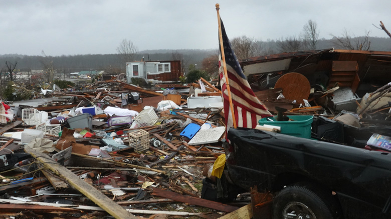 2021 tornado cluster aftermath with a flag