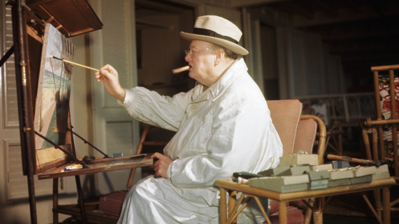 Winston Churchill sat painting smoking cigar