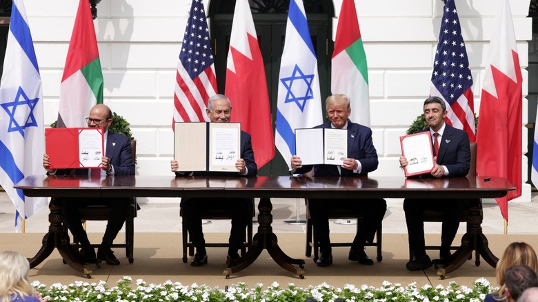 Donald Trump and Benjamin Netanyahu sitting at table