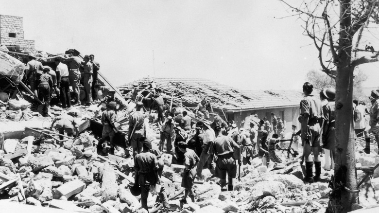Soldiers standing amidst rubble
