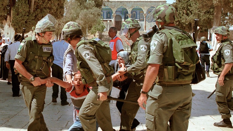 Israeli soldiers carrying Palestinian man