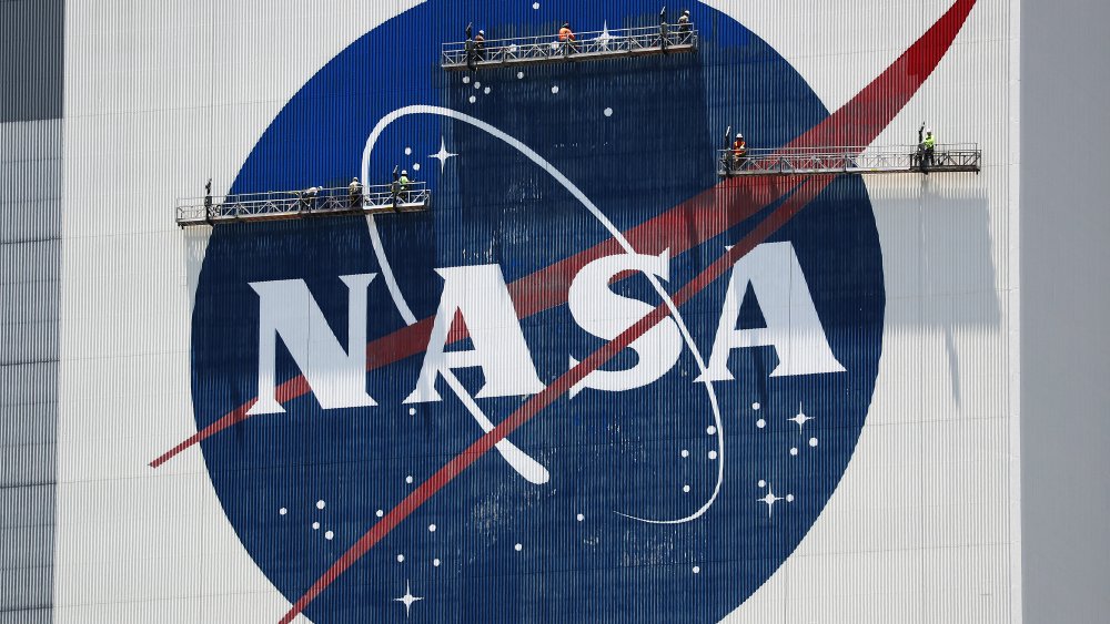 A giant NASA logo undergoing repairs.