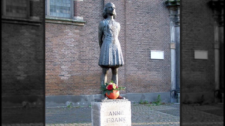 Anne Frank statue with flowers